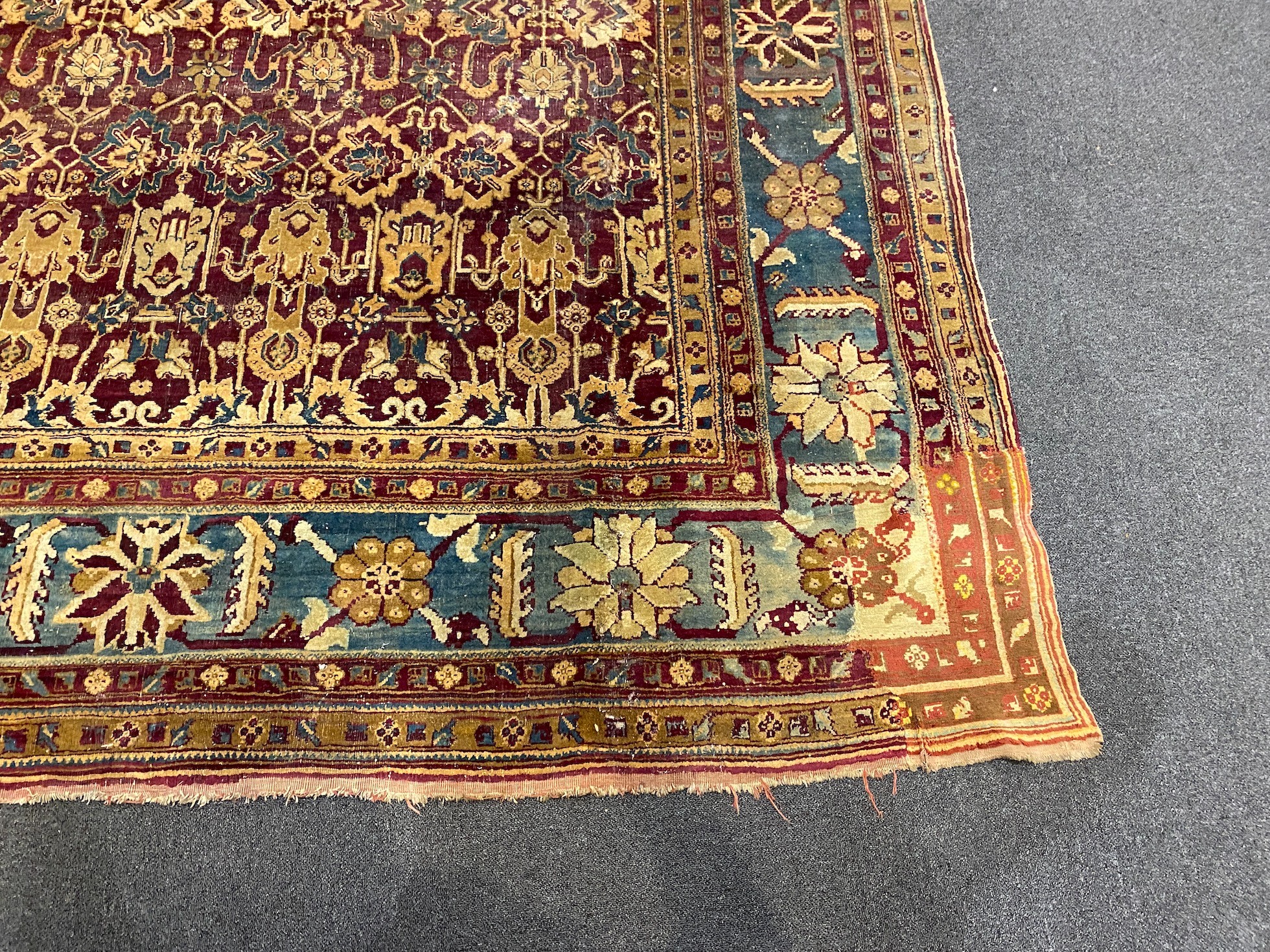A large Sarouk purple ground carpet, approx. 20ft x 12ft. (cut in one area)